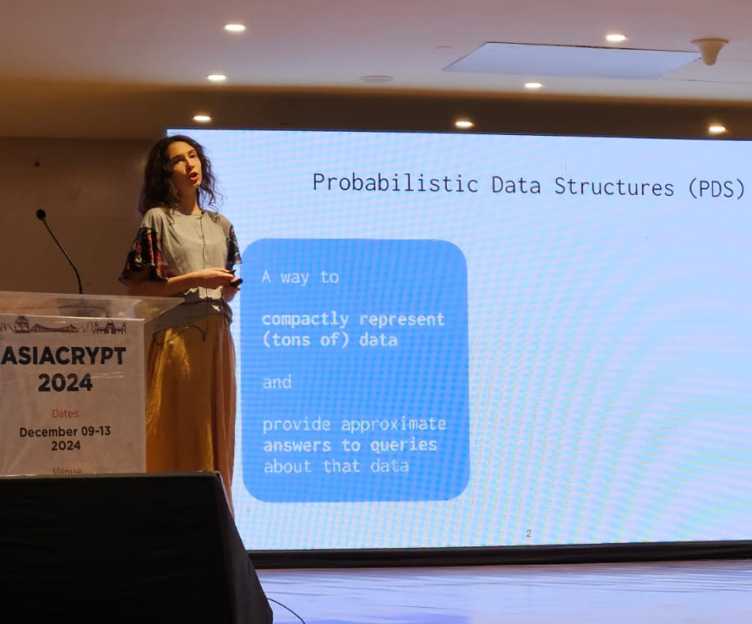 Mia Filic on stage at Asiacrypt 2024.